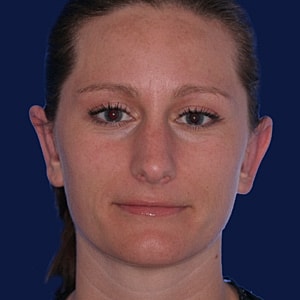Portrait of a woman with neutral expression.
