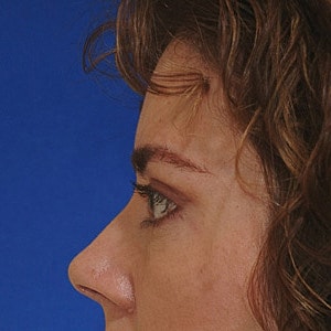 Close-up portrait of a woman with dark hair.