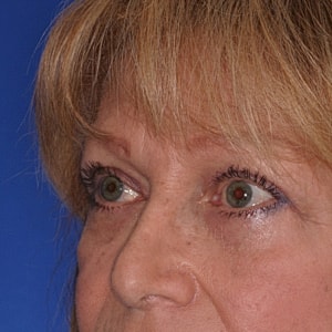 Close-up of eyes against blue background.