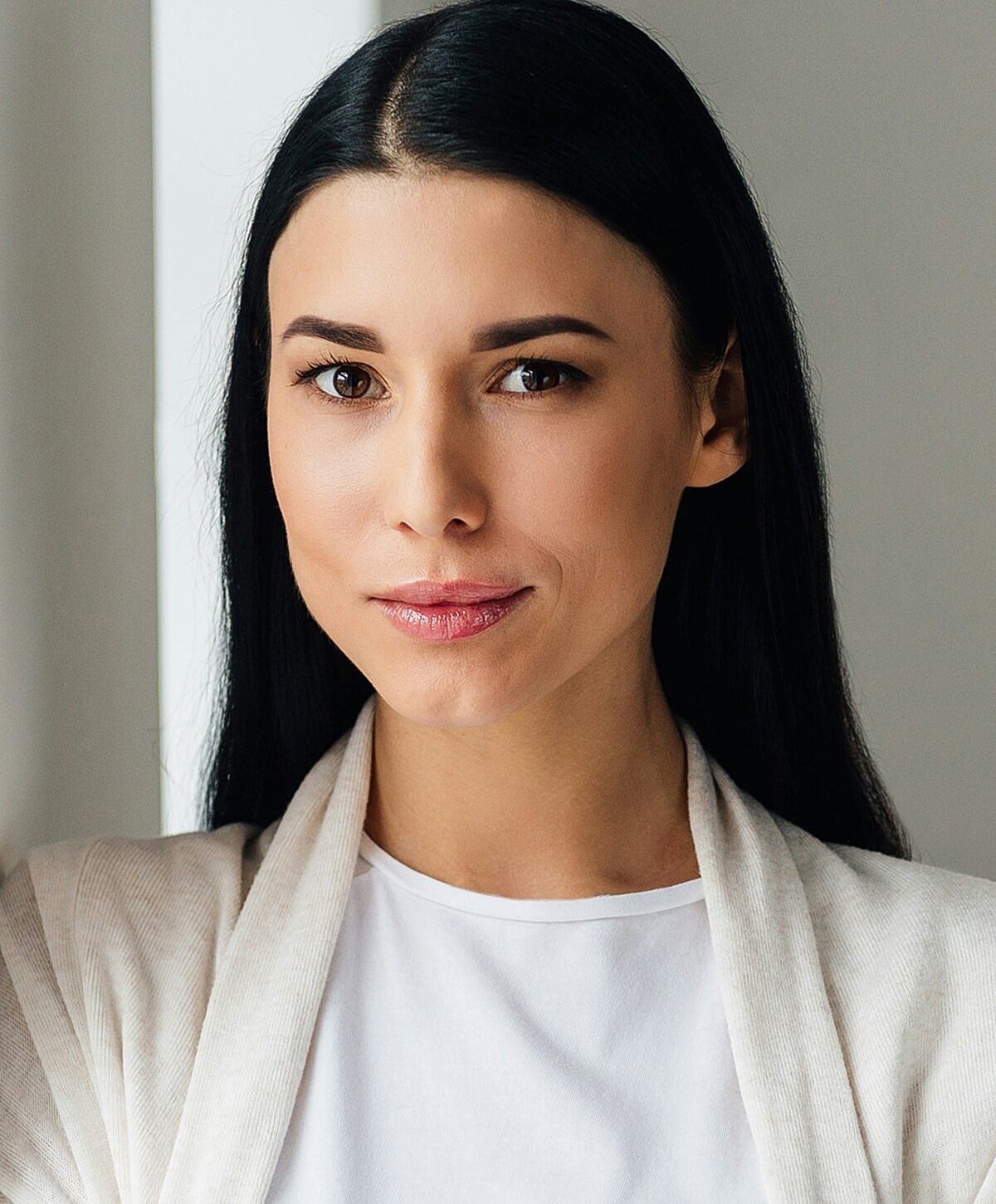Orange County Deep Plane Neck Lift model with long hair, wearing a light cardigan.