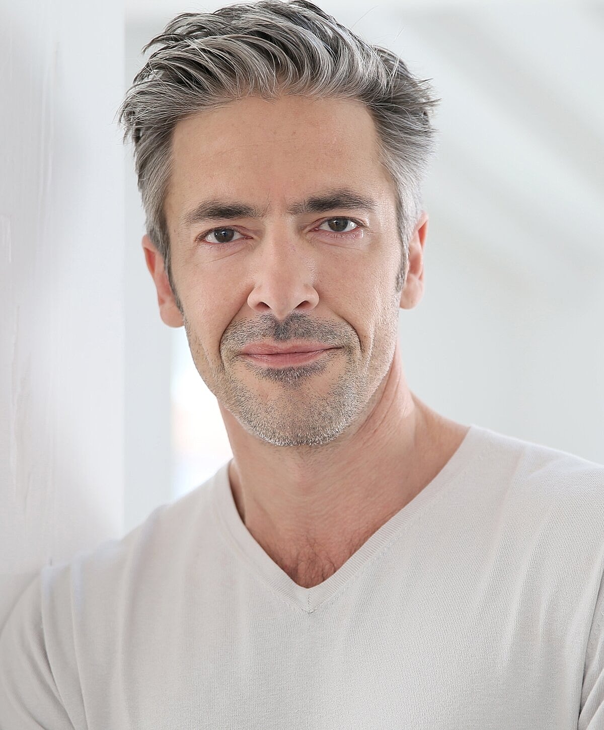 Man with gray hair in a light shirt.