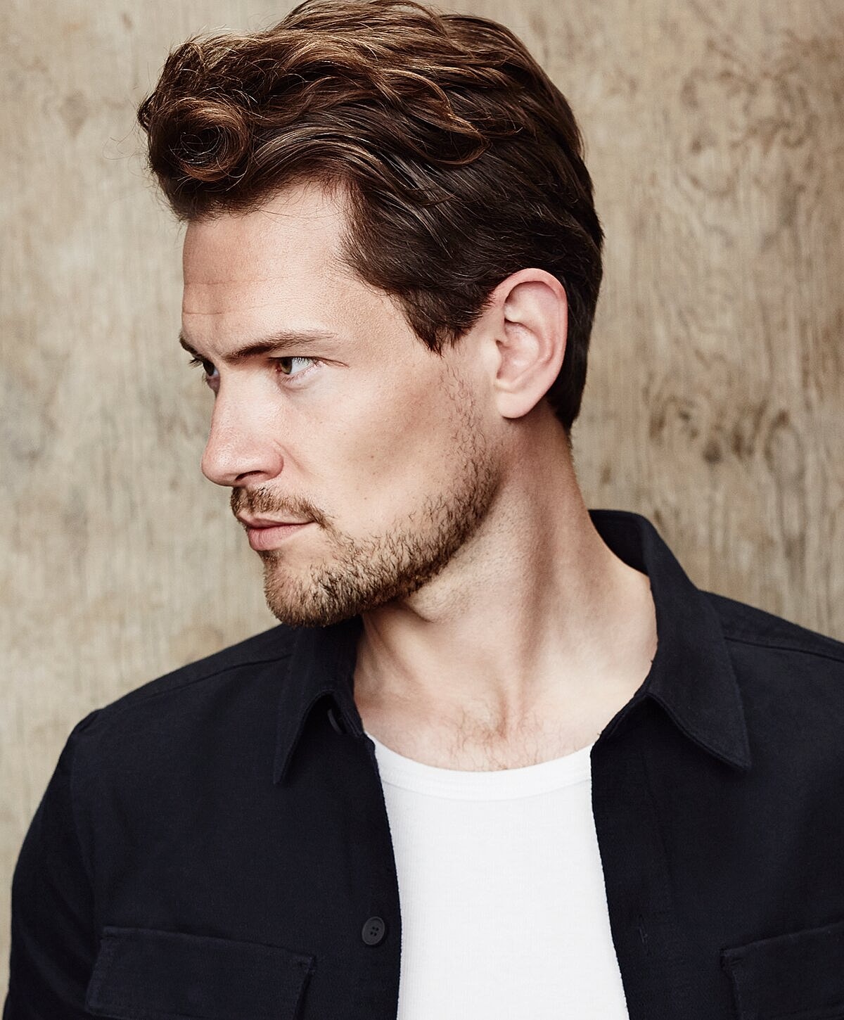 Man with styled hair looking sideways.