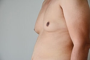 Male torso profile against a neutral background.