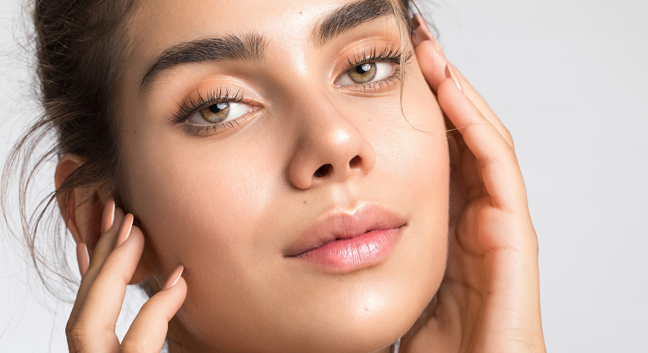 Close-up of a young woman's face with soft features.
