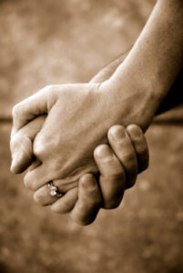 Photo of elderly couple holding hands