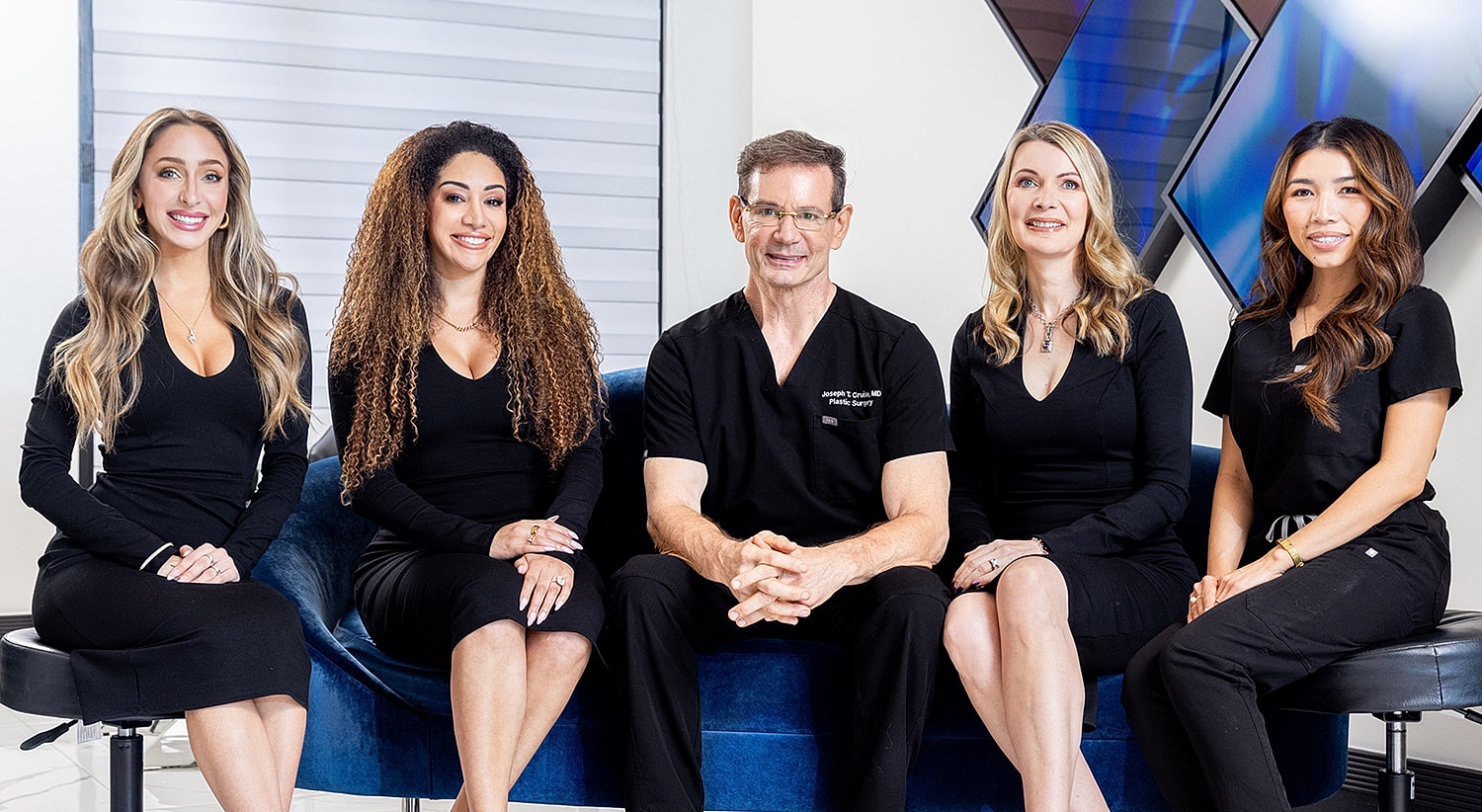 Newport Beach plastic surgery team posing in clinic setting.