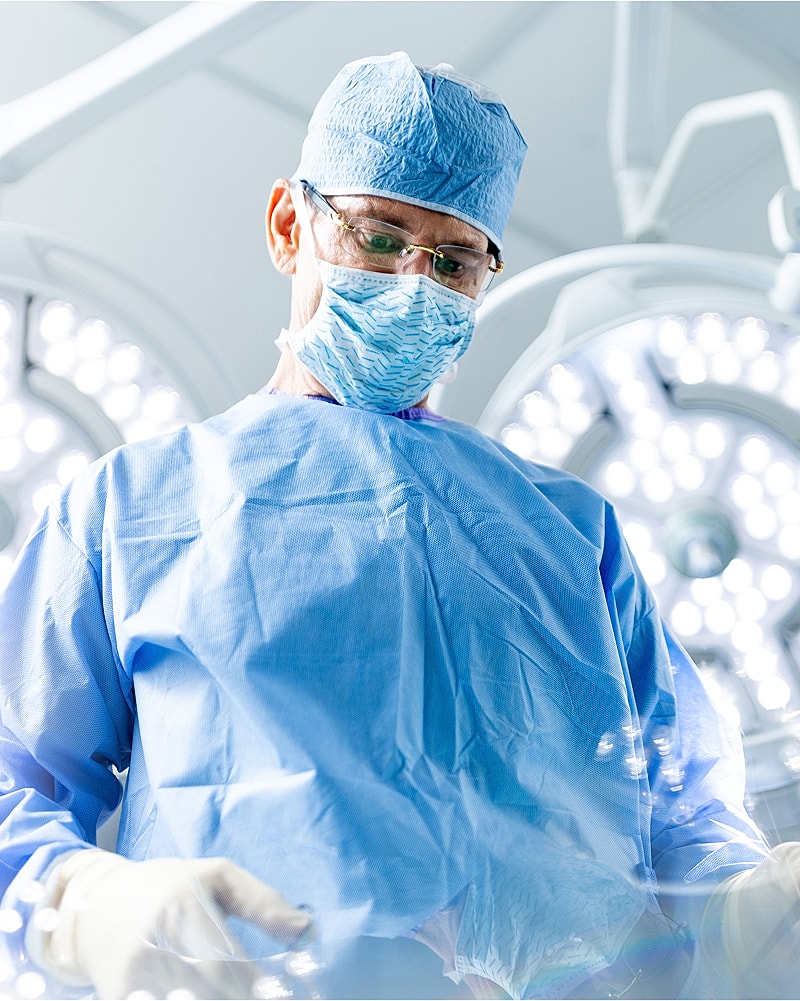 Orange County plastic surgeon focused in a sterile operating room.